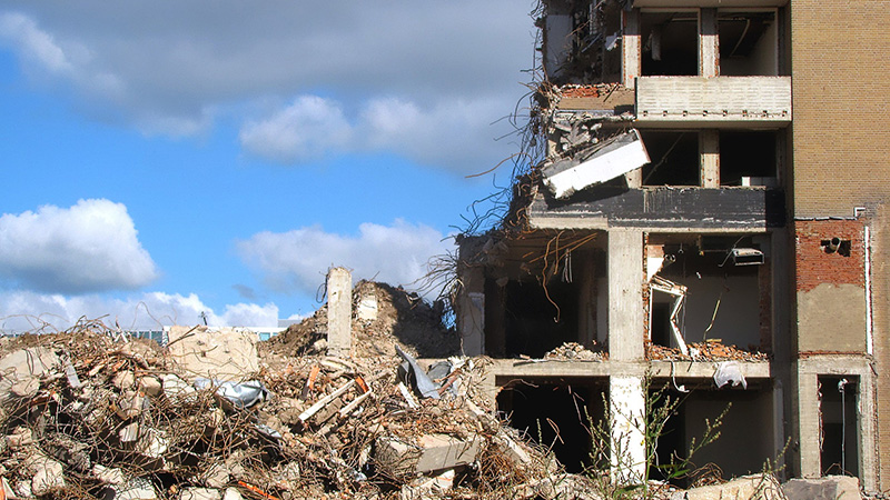 Demolished buildings surrounded by debris